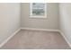 A compact bedroom featuring wall-to-wall carpet and natural light from the window at 1563 Mayflower Sw Ave, Atlanta, GA 30311