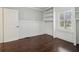 A well-lit bedroom with a built-in bookcase, fresh paint, and hardwood floors at 1563 Mayflower Sw Ave, Atlanta, GA 30311