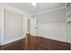 A bright bedroom featuring hardwood floors, fresh paint, and elegant white trim at 1563 Mayflower Sw Ave, Atlanta, GA 30311