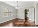 Dining room featuring hardwood floors, neutral walls, and a view into the living room with a fireplace at 1563 Mayflower Sw Ave, Atlanta, GA 30311