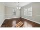 Bright dining room with hardwood floors, a chandelier, and two windows providing natural light at 1563 Mayflower Sw Ave, Atlanta, GA 30311