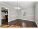 Well-lit dining room with hardwood floors, neutral walls, and classic trim details at 1563 Mayflower Sw Ave, Atlanta, GA 30311