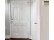 Interior view of a white paneled entry door and trim complemented by the neutral walls at 1563 Mayflower Sw Ave, Atlanta, GA 30311
