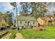 Charming home with a stone foundation, green siding and a grassy front yard at 1563 Mayflower Sw Ave, Atlanta, GA 30311