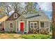 Charming single-story home with stone accents, a bright red door, and a well-maintained front yard at 1563 Mayflower Sw Ave, Atlanta, GA 30311
