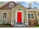 Close-up of the home's entrance featuring a bright red door and stone accents at 1563 Mayflower Sw Ave, Atlanta, GA 30311