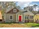 Charming home featuring a red door, stone accents, and classic details at 1563 Mayflower Sw Ave, Atlanta, GA 30311
