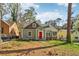 Inviting home with a bright red door, stone accents, and lush landscaping at 1563 Mayflower Sw Ave, Atlanta, GA 30311