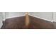 Close-up view highlighting beautiful dark-stained hardwood floors and neutral wall in this home at 1563 Mayflower Sw Ave, Atlanta, GA 30311