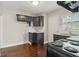 Well-equipped kitchen featuring sleek black cabinets, granite countertops, and stainless-steel appliances at 1563 Mayflower Sw Ave, Atlanta, GA 30311