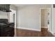 View of the kitchen showcases black appliances and access to additional rooms at 1563 Mayflower Sw Ave, Atlanta, GA 30311