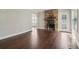 Bright living room showcases a stone fireplace, hardwood floors, and neutral walls at 1563 Mayflower Sw Ave, Atlanta, GA 30311