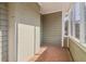 Sunroom with brick walls, brick-tile flooring, and multiple windows overlooking the neighborhood at 1563 Mayflower Sw Ave, Atlanta, GA 30311