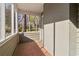 Sunroom with brick walls, brick-tile flooring, and multiple windows overlooking the neighborhood at 1563 Mayflower Sw Ave, Atlanta, GA 30311
