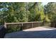 Backyard features a wooden deck with a wooded view, perfect for enjoying the outdoors at 1814 Oak Branch Way, Loganville, GA 30052