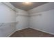 Walk-in closet with carpet and wire shelving for storing clothes and personal items at 1814 Oak Branch Way, Loganville, GA 30052