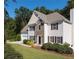 Charming two-story home featuring a stone facade, neutral siding, manicured front yard, and attached two-car garage at 1814 Oak Branch Way, Loganville, GA 30052