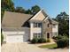 Charming two-story home featuring a stone facade, two-car garage, neutral siding, and a well-manicured front yard at 1814 Oak Branch Way, Loganville, GA 30052