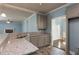 Kitchen featuring granite countertops, gray cabinets, stainless steel sink, and connecting views of other living spaces at 1814 Oak Branch Way, Loganville, GA 30052