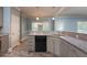 Eat-in kitchen showcasing granite countertops, gray cabinets, black appliances, and tiled floors for a modern look at 1814 Oak Branch Way, Loganville, GA 30052