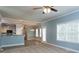 Open-concept living space showcasing plush carpet, bright windows, views of the kitchen, and contemporary design at 1814 Oak Branch Way, Loganville, GA 30052