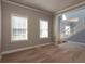 Bright living room featuring neutral-toned walls, plush carpet, white trim, and views of the staircase and adjoining spaces at 1814 Oak Branch Way, Loganville, GA 30052