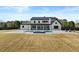 Sprawling backyard featuring a modern farmhouse, pool and spa, outdoor seating, and a large grassy lawn at 2485 Brooks Rd, Dacula, GA 30019