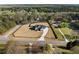 Aerial view of a modern farmhouse on a large lot featuring a private yard with driveway and fence at 2485 Brooks Rd, Dacula, GA 30019