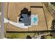 Birds eye view of a modern farmhouse on a large lot featuring a pool, driveway and meticulous landscape at 2485 Brooks Rd, Dacula, GA 30019