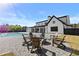Beautiful backyard featuring a modern farmhouse, pool, outdoor seating area with fire pit, and a meticulously landscaped lawn at 2485 Brooks Rd, Dacula, GA 30019