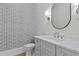 Elegant half bathroom with a marble countertop, modern fixtures, and stylish patterned wallpaper at 2485 Brooks Rd, Dacula, GA 30019