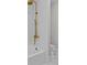 Bright bathroom features a golden rainfall shower head and marble tile flooring at 2485 Brooks Rd, Dacula, GA 30019