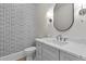 Elegant bathroom featuring patterned wallpaper, a sleek vanity with marble countertop, and modern lighting fixtures at 2485 Brooks Rd, Dacula, GA 30019