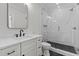 Modern bathroom with a glass shower, marble tiling, and a sleek vanity with black hardware at 2485 Brooks Rd, Dacula, GA 30019