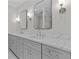 Bathroom vanity with marble countertops, double sinks, and modern lighting and hardware at 2485 Brooks Rd, Dacula, GA 30019