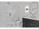Modern bathroom featuring glass shower, black vanity with gold hardware, and stylish lighting at 2485 Brooks Rd, Dacula, GA 30019