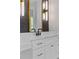 Close-up of the vanity featuring marble countertops, white cabinets, and sleek black fixtures at 2485 Brooks Rd, Dacula, GA 30019