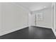 An empty bedroom with neutral walls, black floors, and a window letting in natural light at 2485 Brooks Rd, Dacula, GA 30019