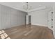 Bright bedroom featuring elegant wall trim, a statement chandelier, and a door to the bathroom at 2485 Brooks Rd, Dacula, GA 30019