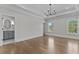 Airy bedroom boasting ample natural light, hardwood flooring, and an ensuite bathroom at 2485 Brooks Rd, Dacula, GA 30019