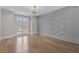 Bright bedroom features custom accent wall, hardwood floors, and natural light from large window at 2485 Brooks Rd, Dacula, GA 30019