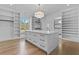 Large walk-in closet featuring an island with marble countertop and ample storage at 2485 Brooks Rd, Dacula, GA 30019