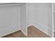 Walk-in closet features wood floor and built-in shelves for ample storage solutions at 2485 Brooks Rd, Dacula, GA 30019