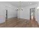 Bright dining room featuring beautiful hardwood floors and a modern gold chandelier at 2485 Brooks Rd, Dacula, GA 30019