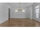 Bright dining area with hardwood floors, stylish lighting, and classic moldings at 2485 Brooks Rd, Dacula, GA 30019