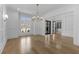 Open dining area with hardwood floors, stylish chandelier, and ample natural light at 2485 Brooks Rd, Dacula, GA 30019