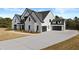 Beautiful two-story white brick home with attached three-car garage and long driveway at 2485 Brooks Rd, Dacula, GA 30019