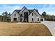 Stunning two-story home with a modern white brick exterior and black trim at 2485 Brooks Rd, Dacula, GA 30019
