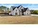 Eye-catching two-story white brick home with black trim, offering modern elegance at 2485 Brooks Rd, Dacula, GA 30019