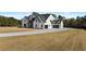 Attractive two-story white brick home with long driveway and well-manicured lawn at 2485 Brooks Rd, Dacula, GA 30019